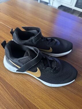 Kids Black Nike  shoes  with Gold Swoosh